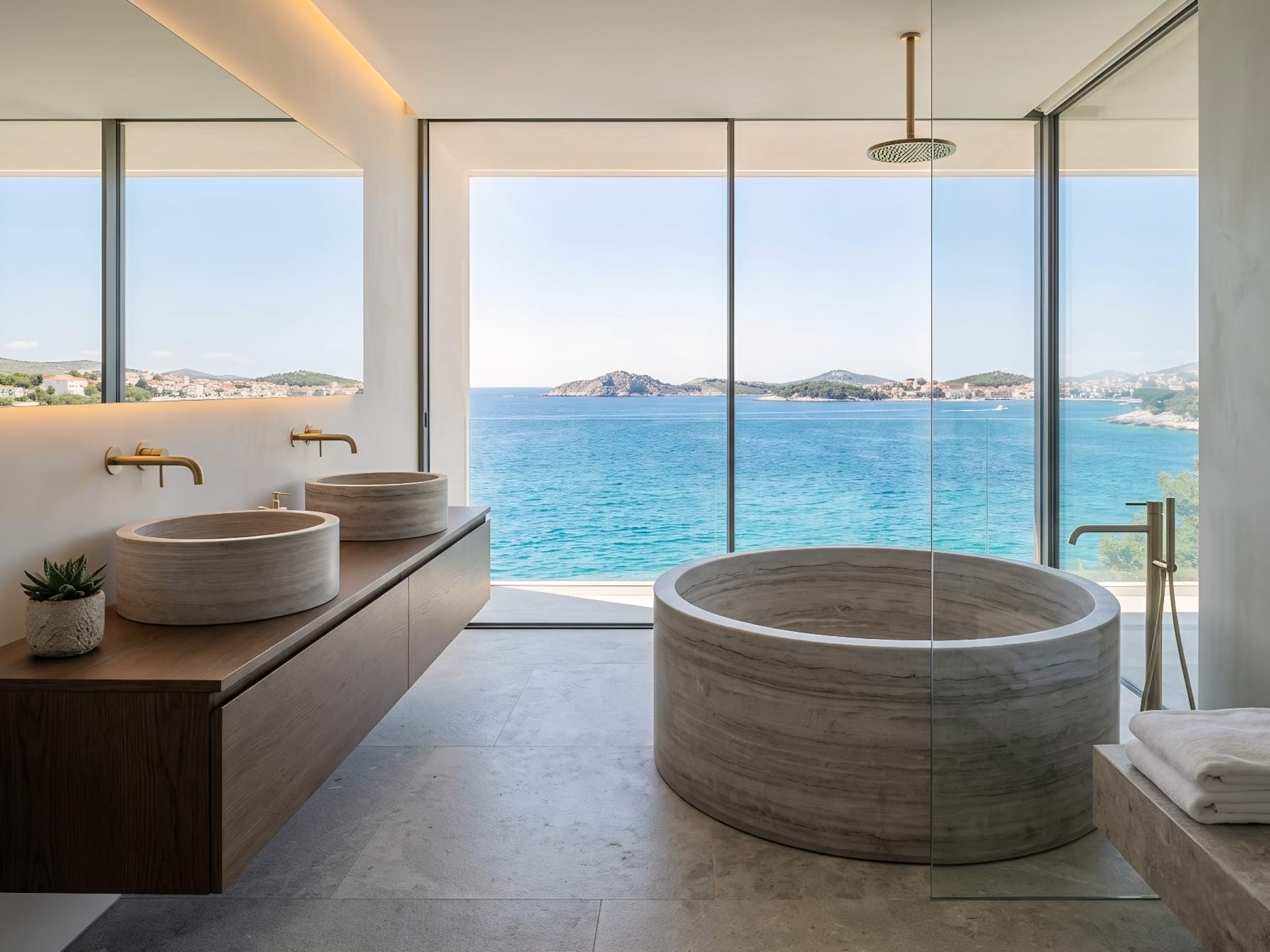 Komplet za luksuznu kupaonicu Umivaonici i kada klesani od mramora u modernoj kupaonici s pogledom na Jadran Komplet za luksuznu kupaonicu Umivaonici i kada klesani od mramora u modernoj kupaonici s pogledom na Jadran